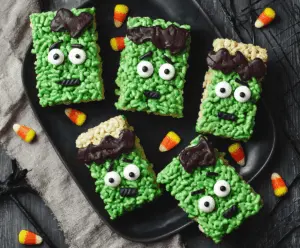 Colorful Frankenstein Rice Krispie Treats decorated with green icing, candy eyes, and fun monster details, perfect for Halloween parties.