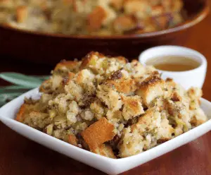 Golden bread stuffing with herbs and vegetables, served as a flavorful holiday side dish.