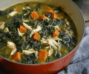 Hearty chicken sweet potato kale soup in a bowl, highlighting healthy ingredients and vibrant colors.