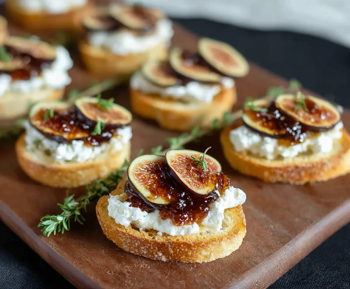 Delicious fig jam and creamy goat cheese crostini on a elegant platter