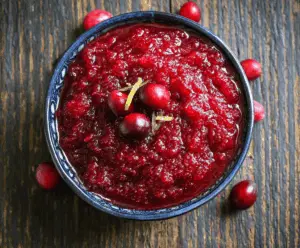 Delicious no cook cranberry sauce in a clear glass bowl, perfect for holiday meals.