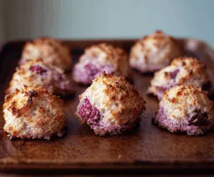 Delicious Raspberry Coconut Macaroons Cookies on a white plate, featuring vibrant raspberry swirls and toasted coconut flakes.