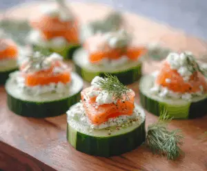 Delicious smoked salmon cucumber bites garnished with fresh herbs, perfect for parties and appetizers.
