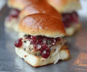 Delicious turkey cranberry sliders on a plate with fresh ingredients