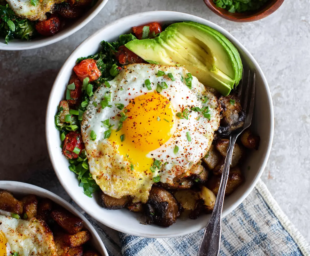 Healthy egg breakfast bowls with fresh vegetables and herbs, perfect for a nutritious morning meal