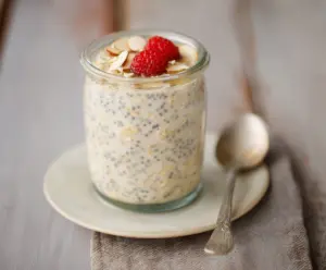 Creamy honey vanilla overnight oats in a glass jar with fresh berries on top, ideal for a healthy breakfast.