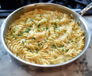 Delicious one pan garlic parmesan pasta served in a bowl, garnished with fresh herbs.