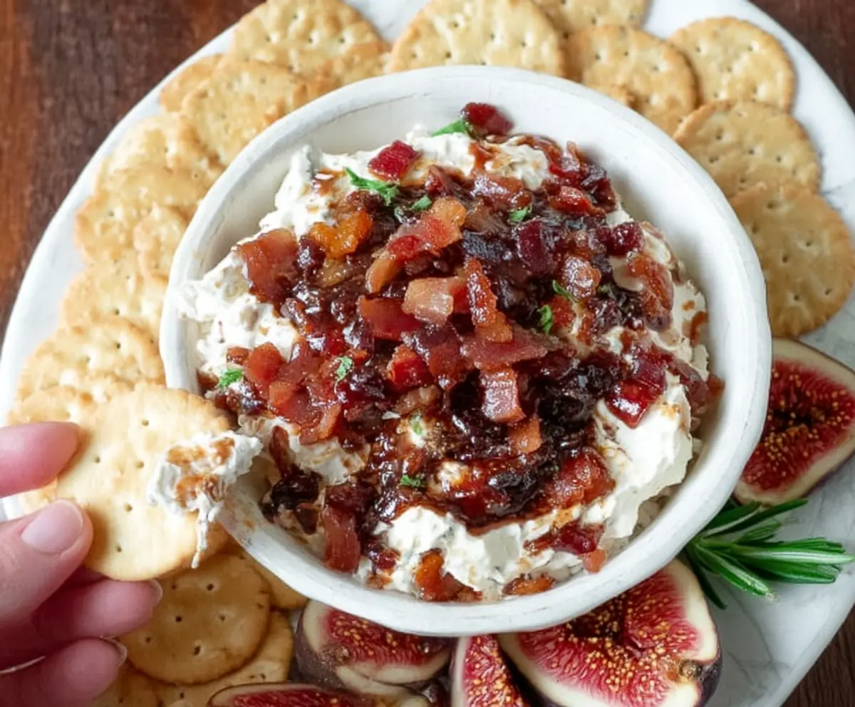 Creamy Fig and Bacon Boursin cheese dip served with fresh crackers and herbs.