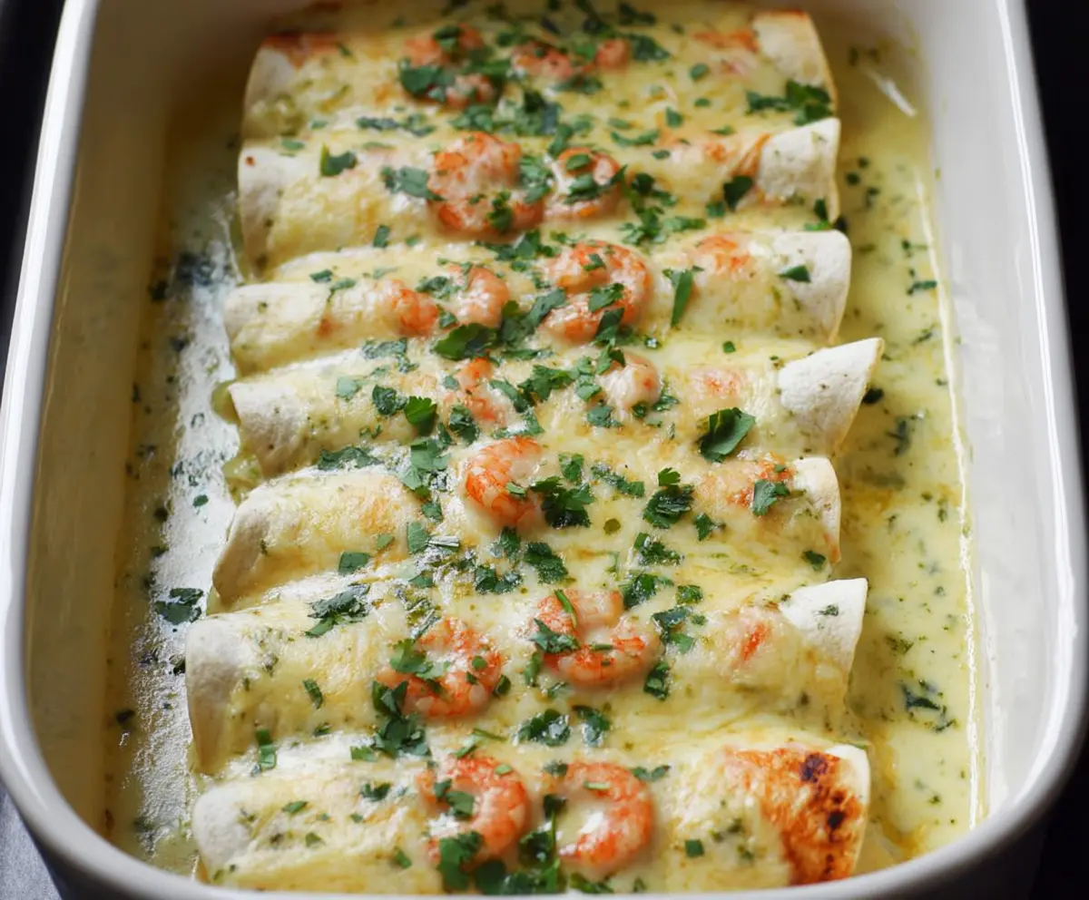 Delicious shrimp enchiladas topped with creamy poblano sauce and melted cheese.