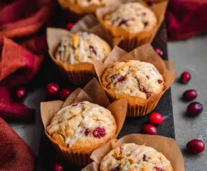 Delicious sourdough cranberry orange muffins fresh out of the oven, showcasing a golden crust and vibrant cranberry filling.