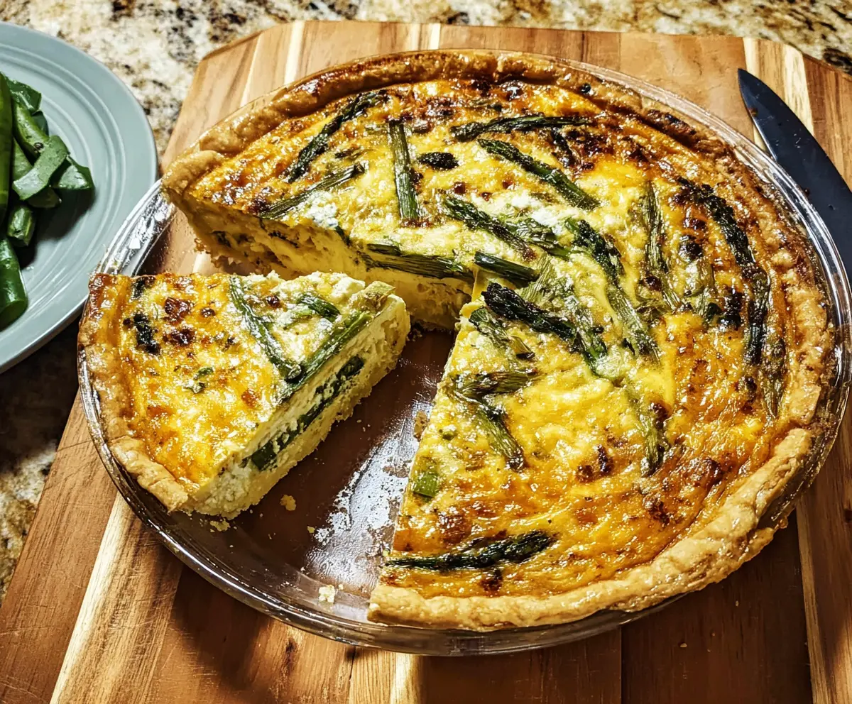 Delicious asparagus and Gruyère cheese quiche with a golden pastry crust, perfect for brunch.
