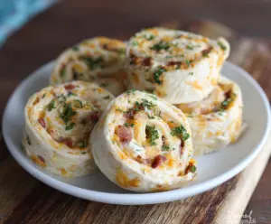 Delicious Bacon Cheddar Ranch Pinwheels with crispy bacon, melted cheddar cheese, and creamy ranch filling.