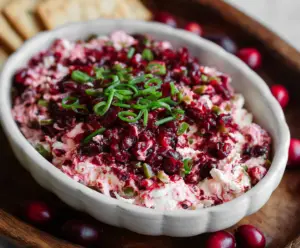 Creamy cranberry jalapeño cream cheese dip served with fresh vegetables and chips.