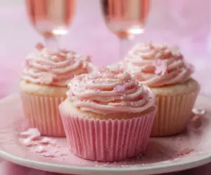 Delicious pink champagne cupcakes topped with swirls of frosting for a festive celebration.